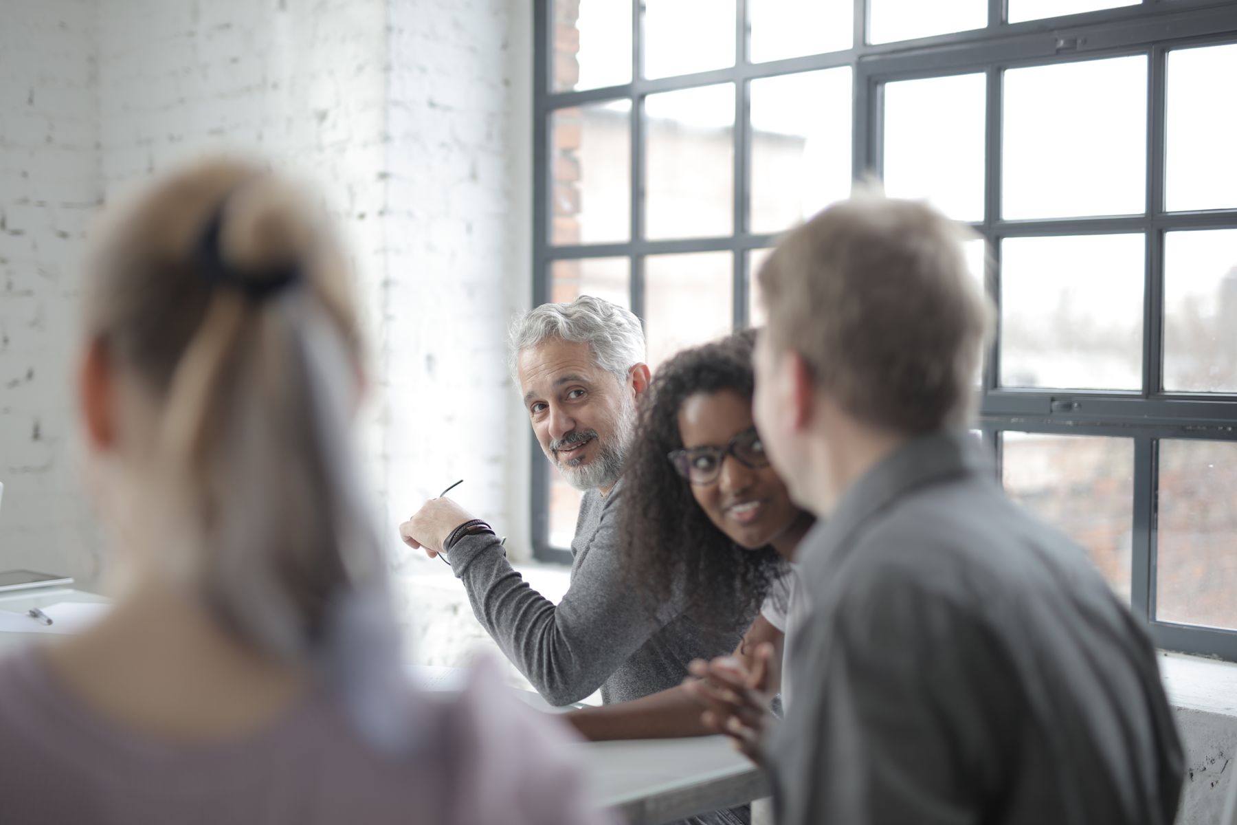 Colleagues talking together in a bright office